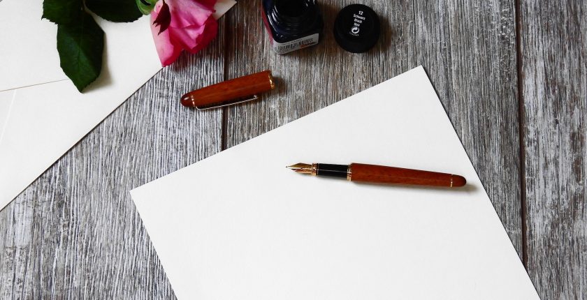 a paper and pen on a table